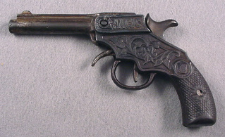 side view of "Magic" cap pistol cast iron